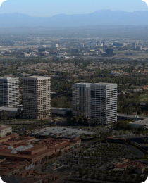 Newport Beach office towers above the surrounding low-rise, in the Orange County market served by Peninsula CRE Group